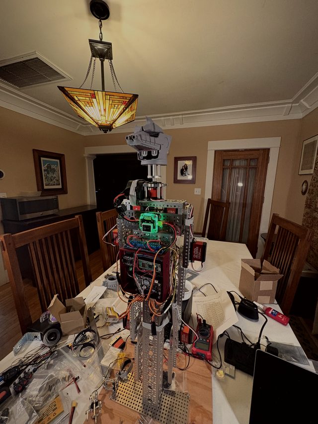 Wide view of the early skeleton on the workbench, laptop and parts around it