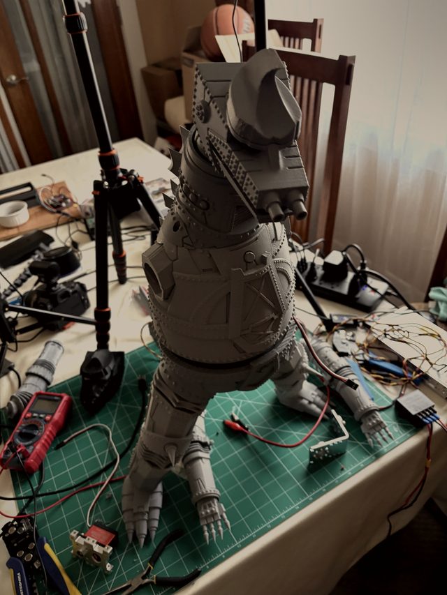 Fully assembled MechaGodzilla standing on a cutting mat, rear three-quarter view