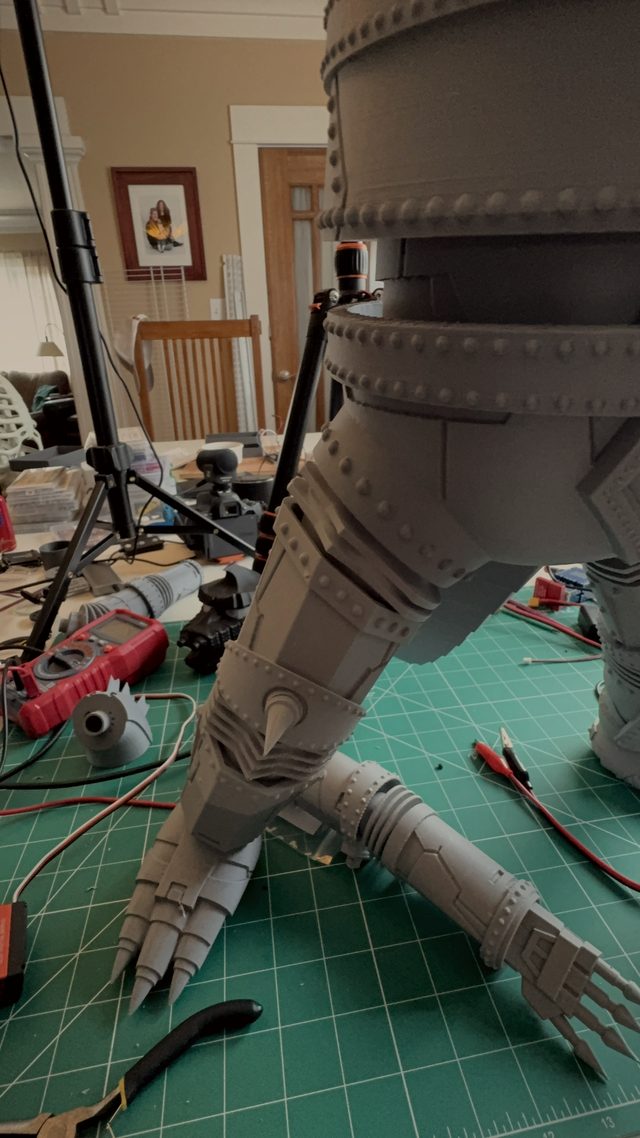Tall close-up of MechaGodzilla's riveted legs and clawed hands during assembly