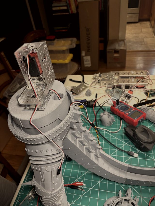 Aluminum servo bracket mounted on the 3D-printed waist hub, tail sections and wiring on the bench