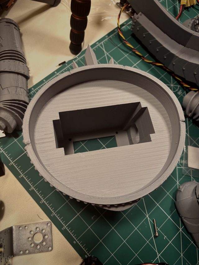 Hollowed 3D-printed torso shell interior showing the integrated servo mount cavity