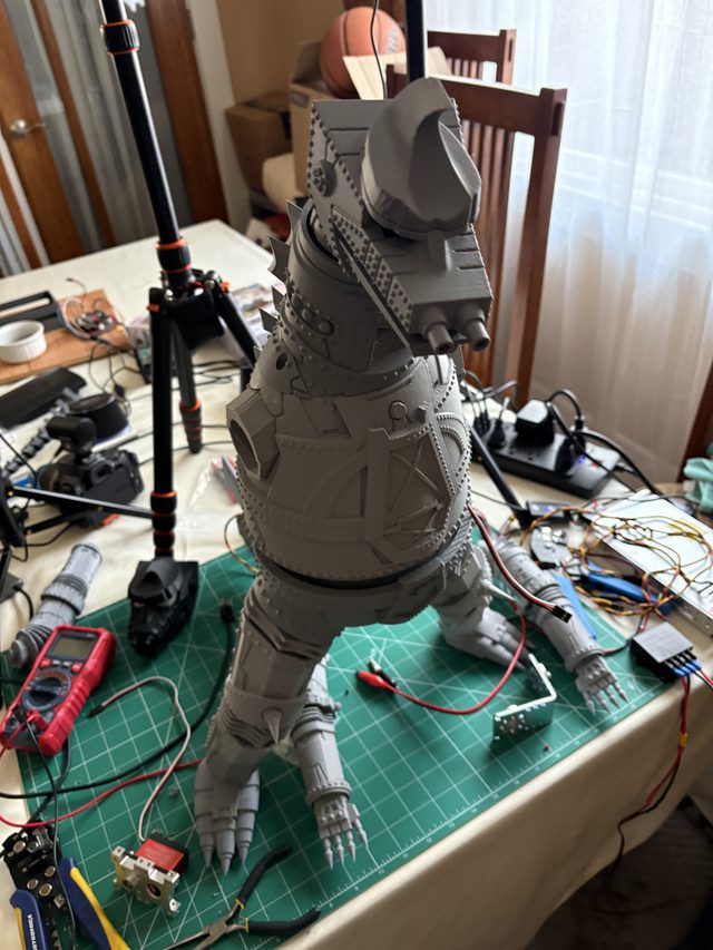 Fully assembled MechaGodzilla standing on a cutting mat, rear three-quarter view