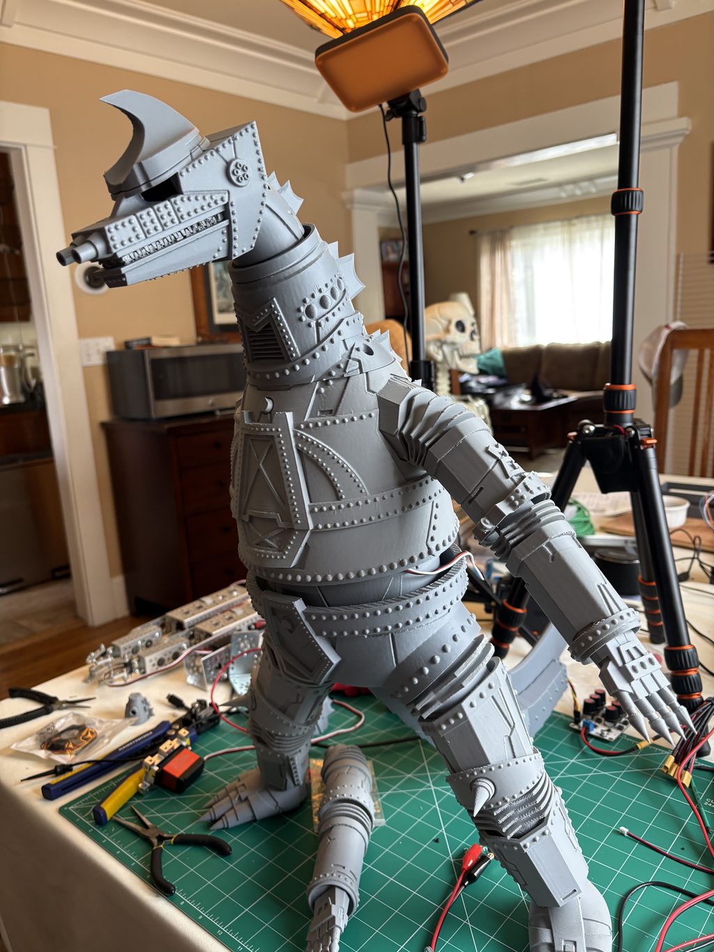 Fully assembled 3D-printed MechaGodzilla animatronic standing on the workbench