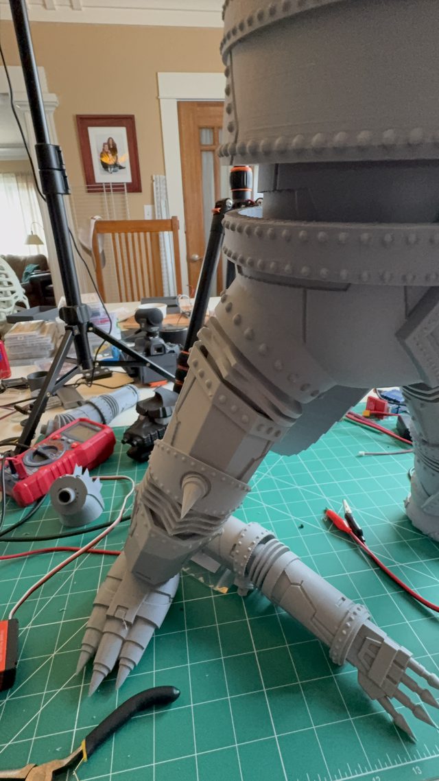Tall close-up of MechaGodzilla's riveted legs and clawed hands during assembly