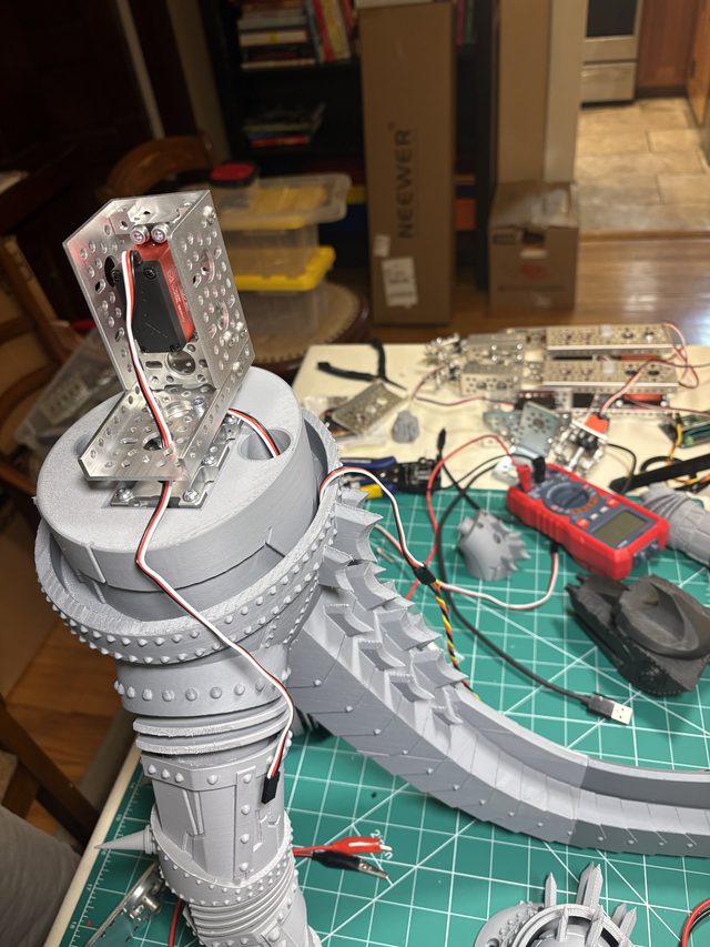 Aluminum servo bracket mounted on the 3D-printed waist hub, tail sections and wiring on the bench