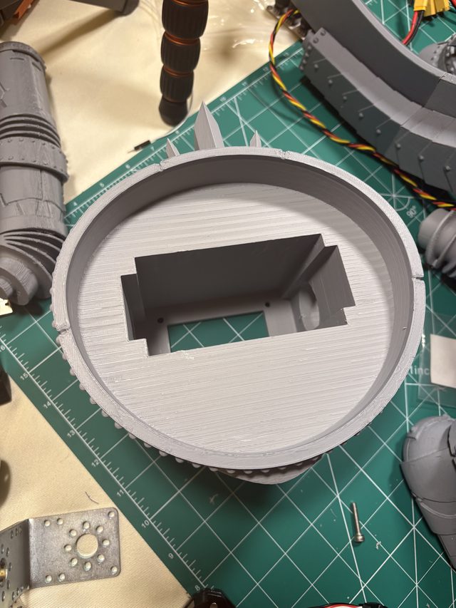 Hollowed 3D-printed torso shell interior showing the integrated servo mount cavity